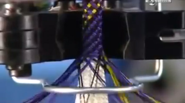 How climbing ropes are made. The white strands of core yarn are covered by a weave of colorful sheath fibers.
